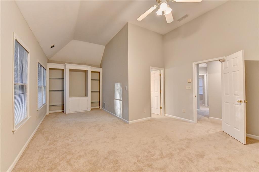 655 Golden Meadows Lane Suwanee, GA 30024 - Photo 31 of 72 an empty room with chandelier fan and closet