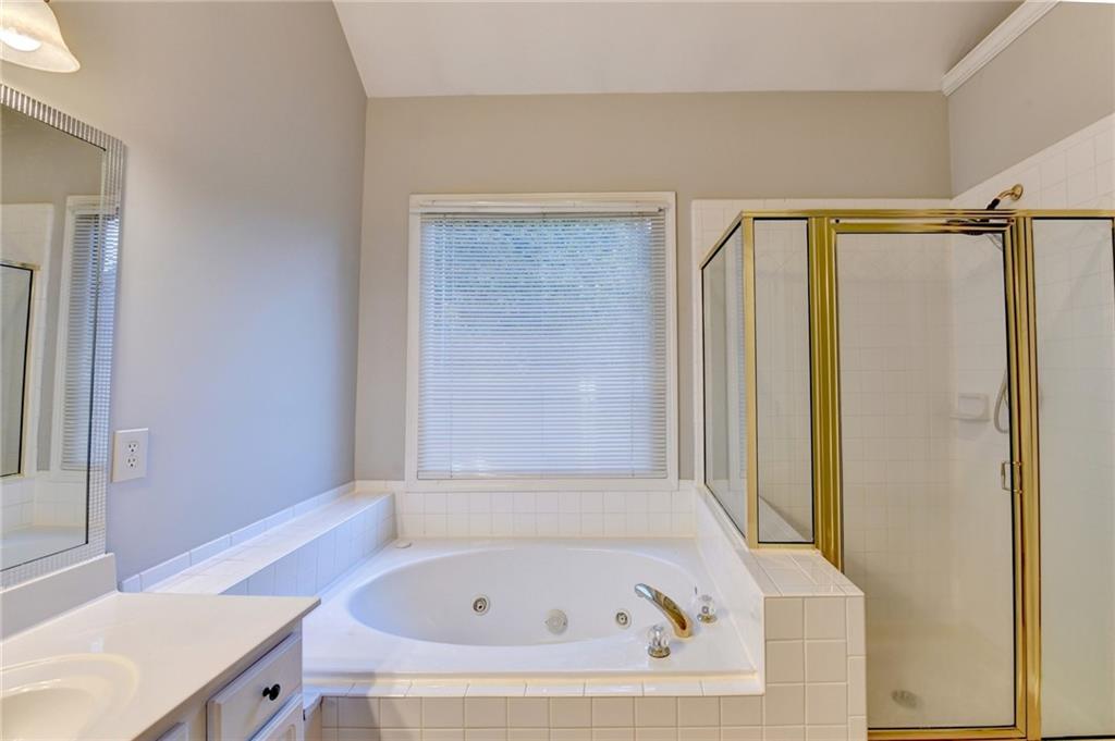 655 Golden Meadows Lane Suwanee, GA 30024 - Photo 34 of 72 a bathroom with a tub and a sink