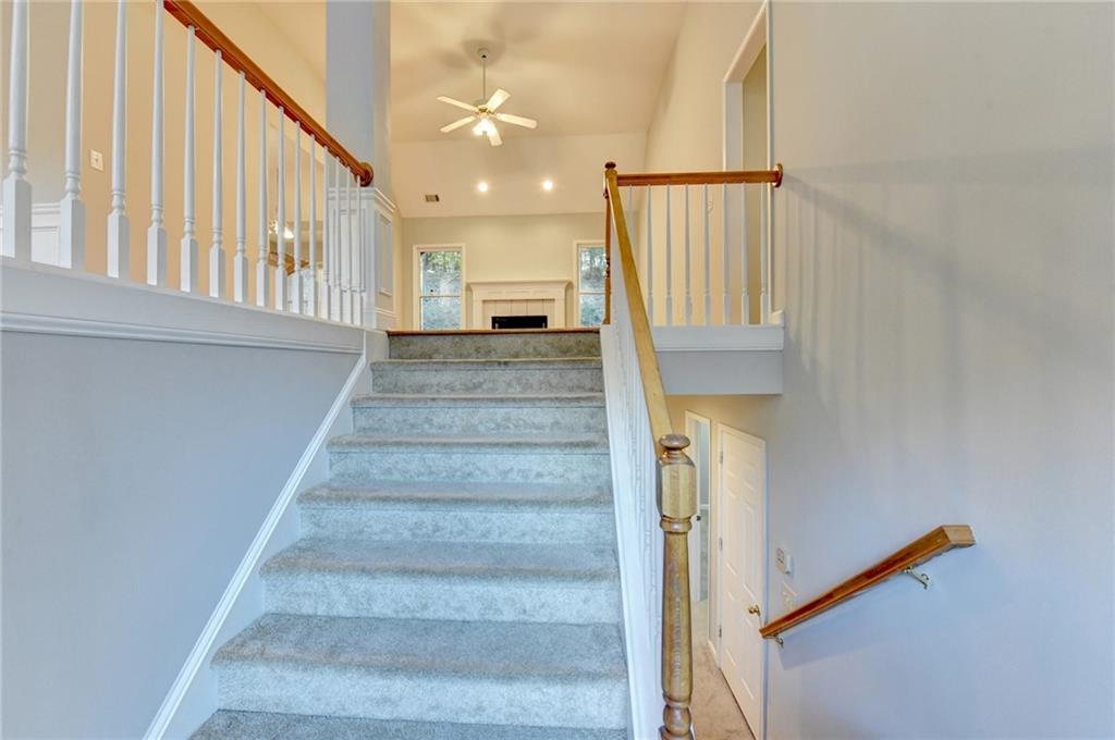 655 Golden Meadows Lane Suwanee, GA 30024 - Photo 4 of 72 a view of staircase with white walls and a window