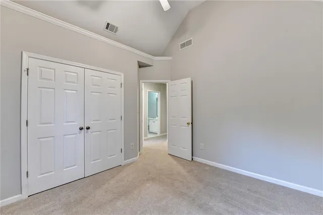 a view of empty room with wooden floor and ceiling fan