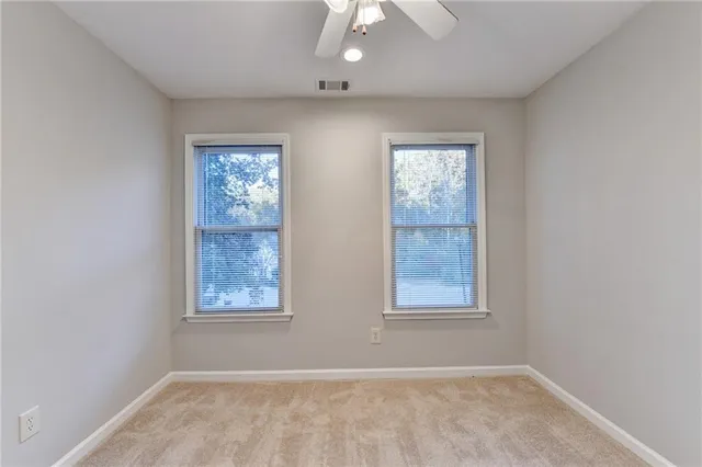 a kitchen with granite countertop a stove a sink and a refrigerator