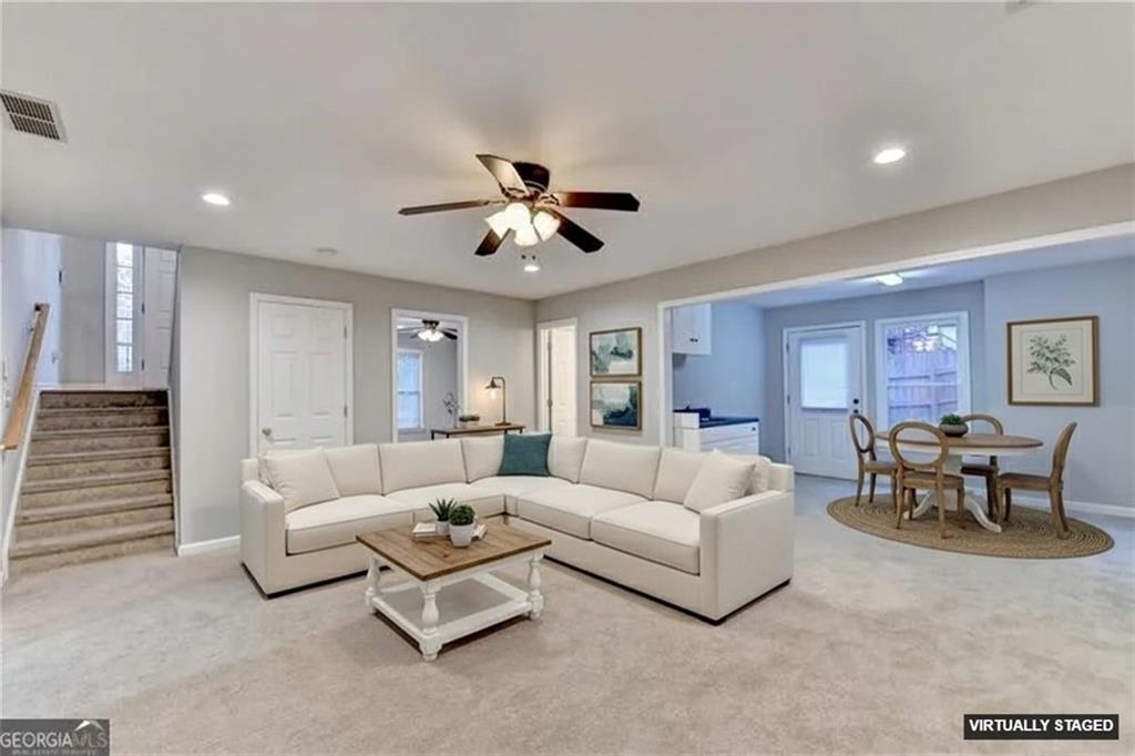 655 Golden Meadows Lane Suwanee, GA 30024 - Photo 47 of 72 a living room with furniture and a ceiling fan