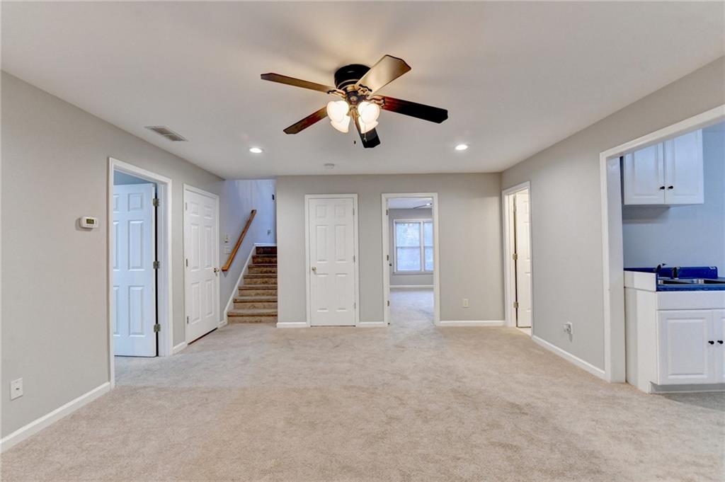 655 Golden Meadows Lane Suwanee, GA 30024 - Photo 48 of 72 a view of empty room with wooden floor and ceiling fan