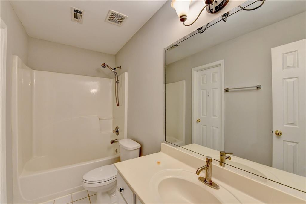 655 Golden Meadows Lane Suwanee, GA 30024 - Photo 53 of 72 a bathroom with a sink a toilet and shower