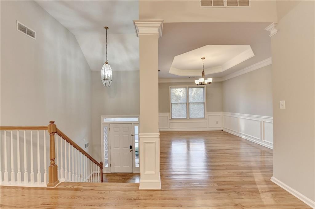 655 Golden Meadows Lane Suwanee, GA 30024 - Photo 6 of 72 a view of a room with wooden floor and white walls