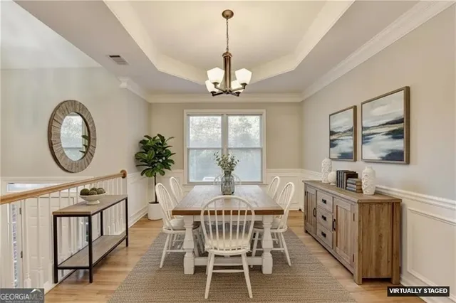 a view of a dining room with furniture window and wooden floor