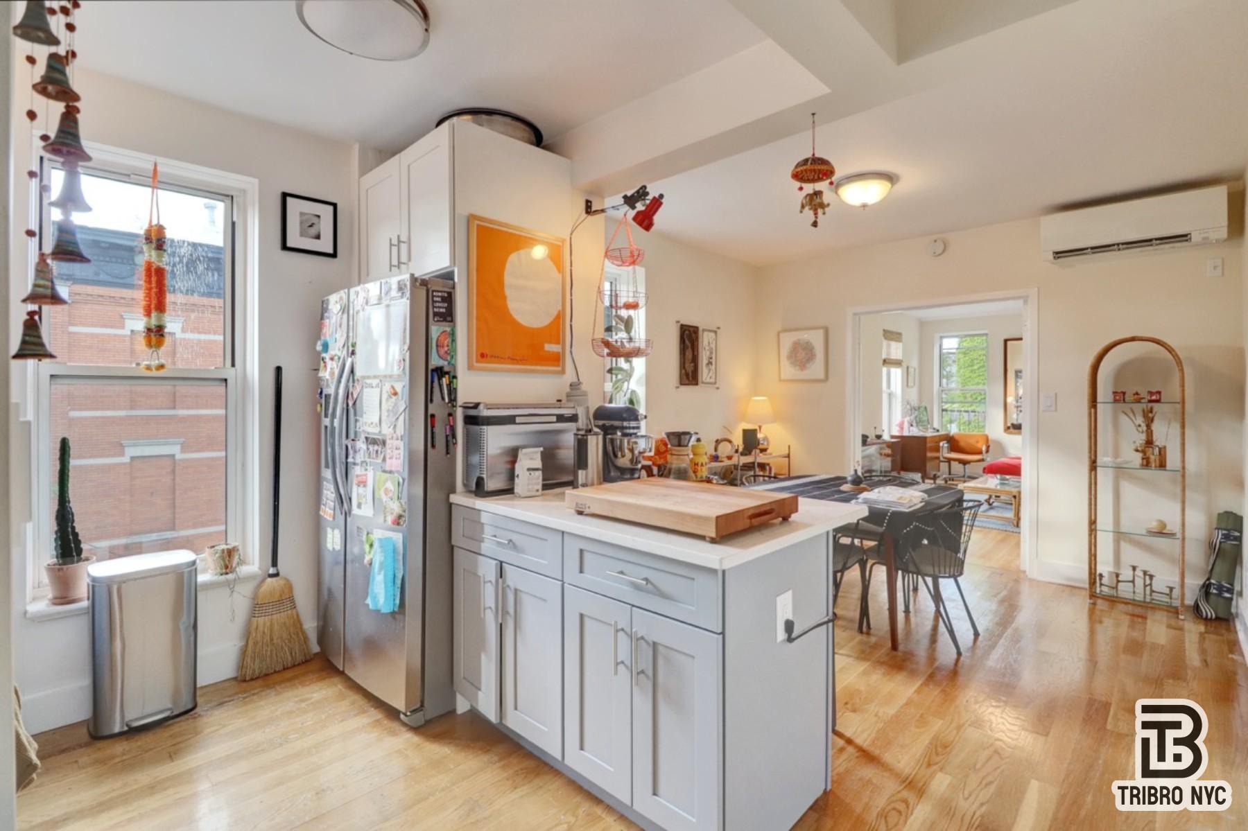 955 Seneca Avenue, Unit 3D Queens, NY 11385 - Photo 3 of 7 a kitchen with a refrigerator a stove a sink dishwasher and wooden cabinets with wooden floor