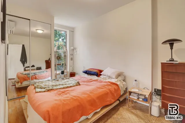 a bedroom with bed and window