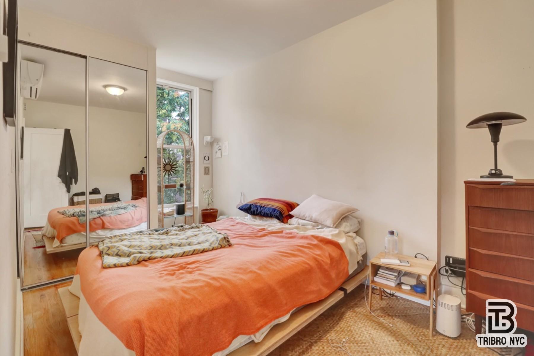 955 Seneca Avenue, Unit 3D Queens, NY 11385 - Photo 5 of 7 a bedroom with bed and window