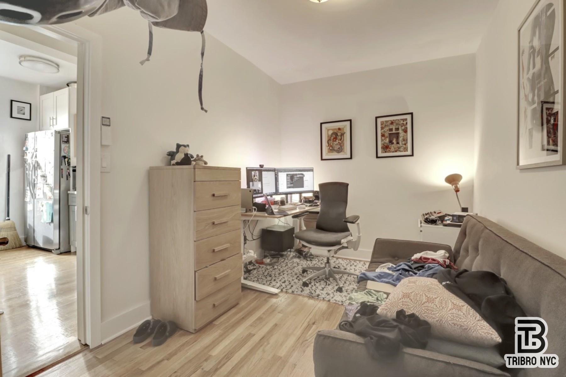 955 Seneca Avenue, Unit 3D Queens, NY 11385 - Photo 6 of 7 a bed room with furniture and a window