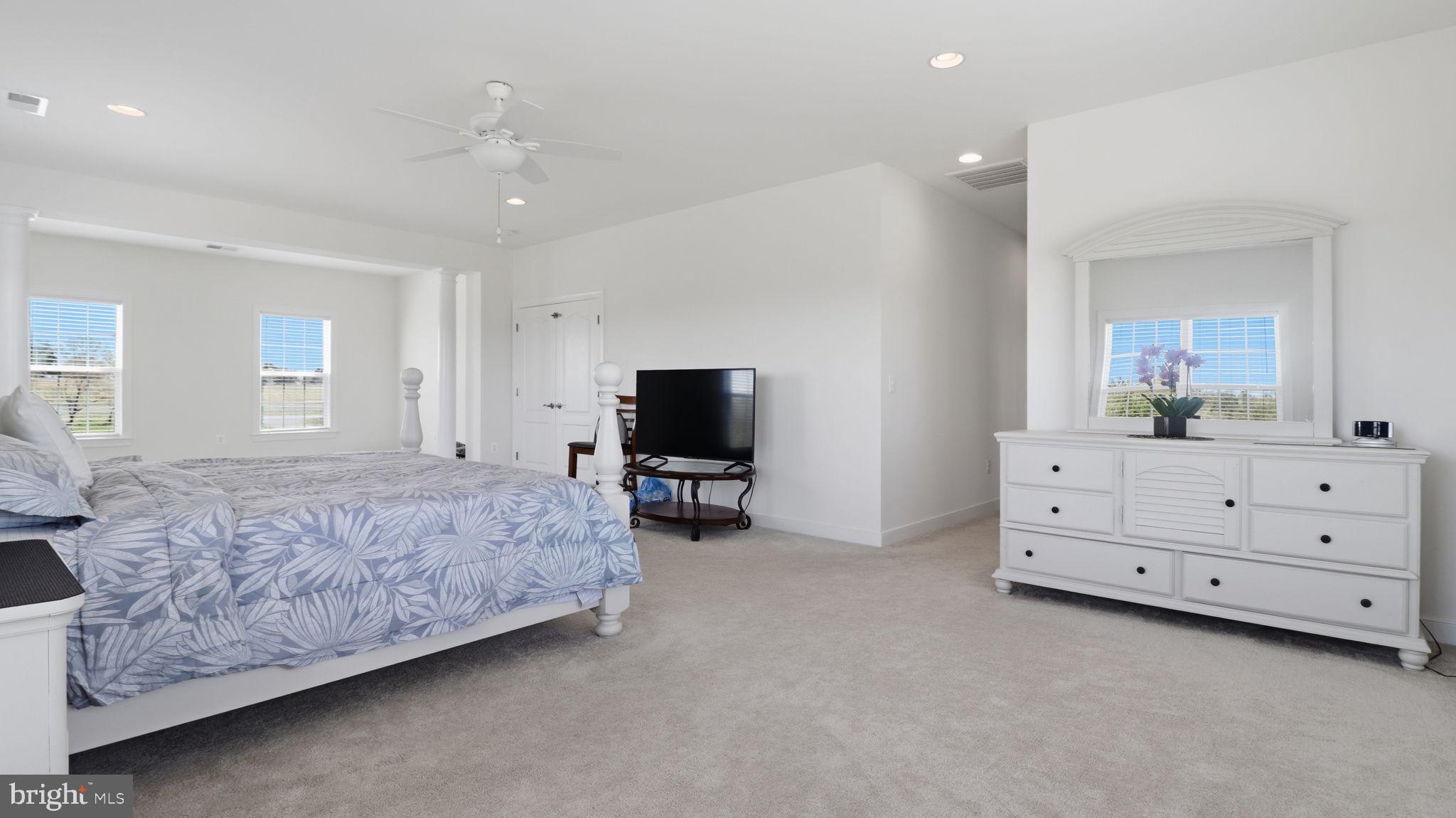 11502 Aden Road Nokesville, VA 20181 - Photo 81 of 106 a spacious bedroom with a bed and a flat screen tv