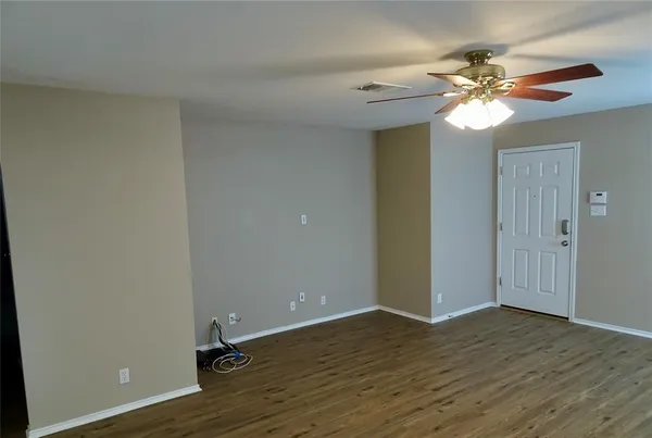 a view of a chandelier fan and hardwood floor
