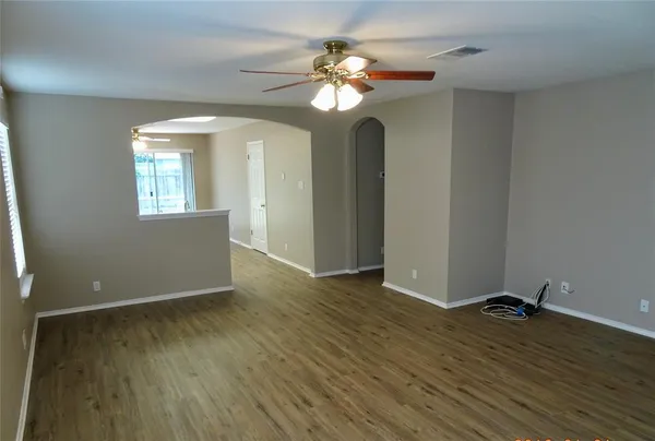 wooden floor in an empty room with a window