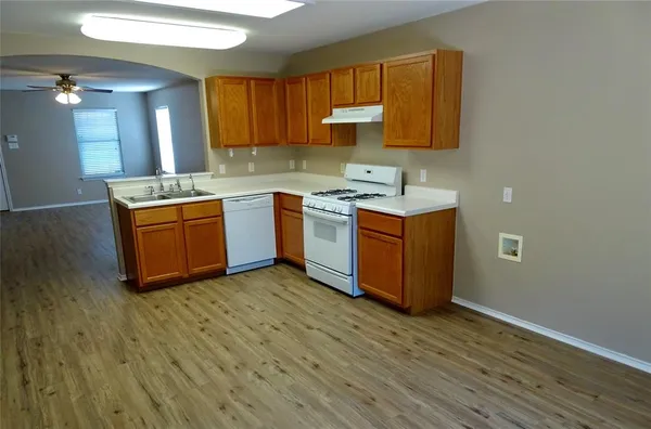 a kitchen with wooden floors and a sink