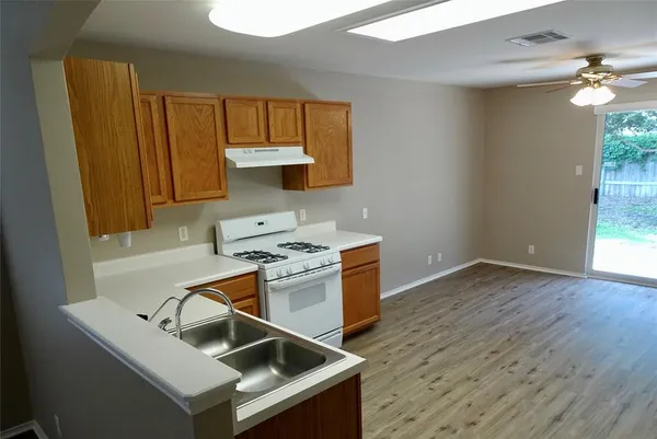 a kitchen that has a sink and a stove in it
