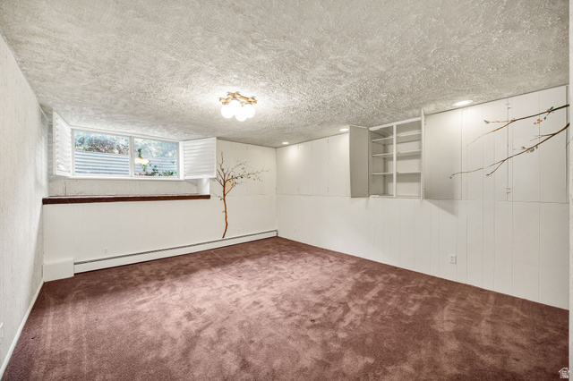 1365 Sumac Drive Logan, UT 84321 - Photo 39 of 66 Spacious room featuring carpeting, a multi-pane window with plantation shutters, built-in shelving, and recessed lighting, with additional flush-mount lighting