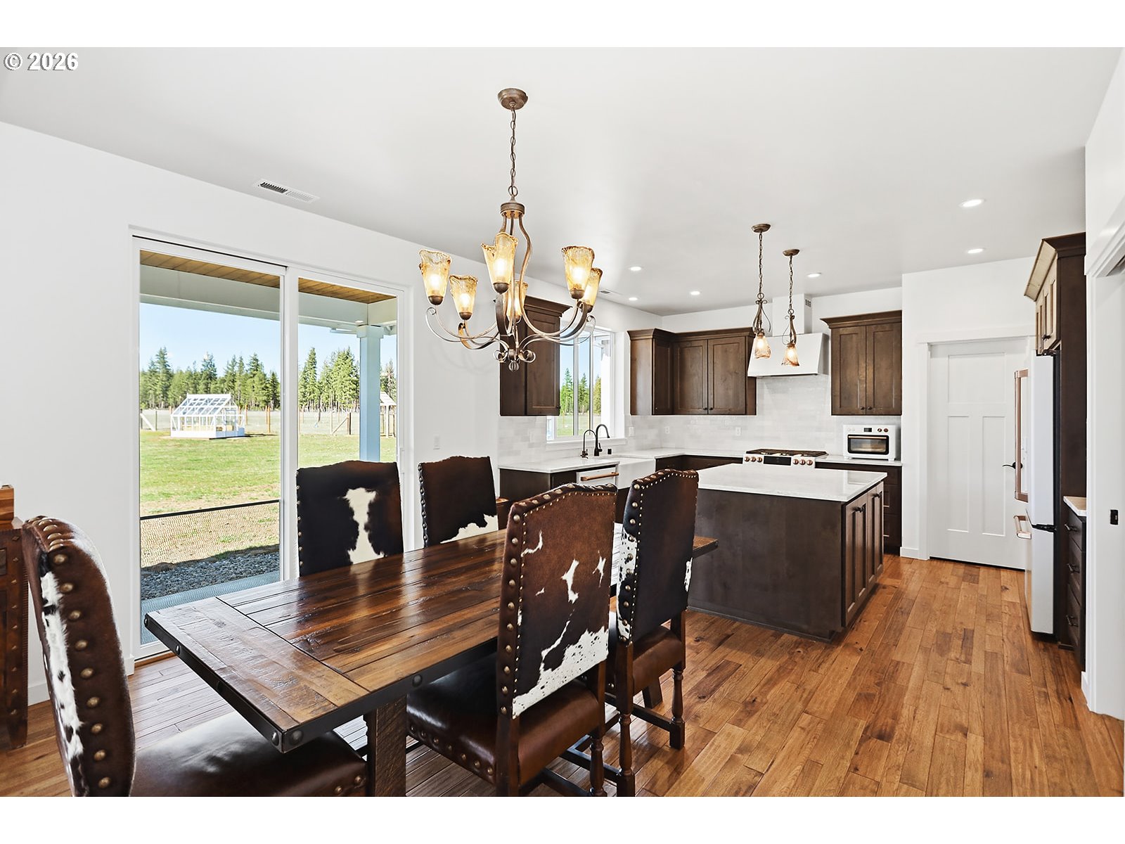 24 Bacon Creek Road Glenwood, WA 98619 - Photo 15 of 48 a view of a dining room with furniture a chandelier and wooden floor
