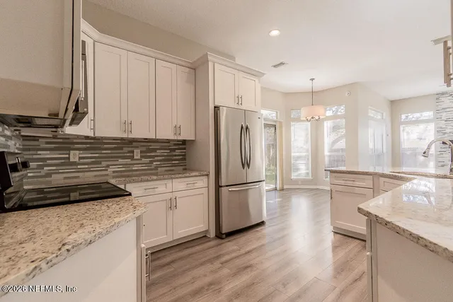 a kitchen with a refrigerator and a sink