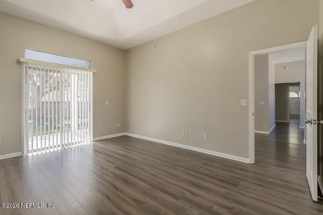 wooden floor in an empty room with a window