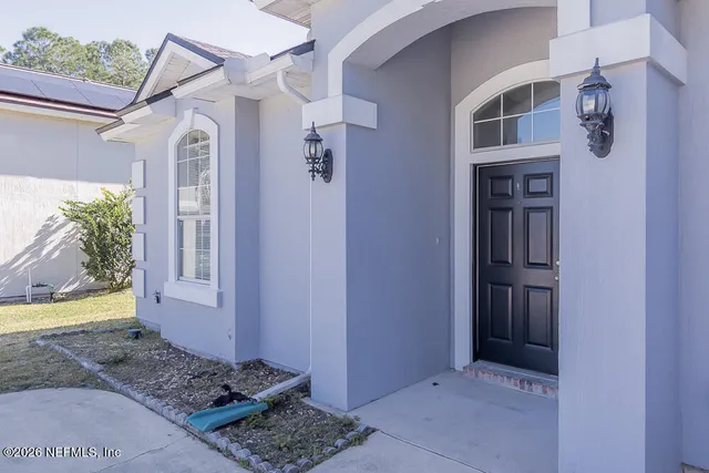 a view of a wooden door and a window