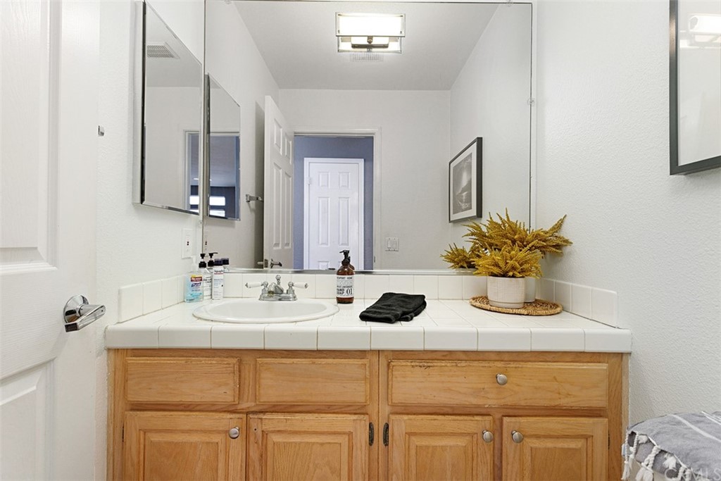 3660 Via Bernardo Oceanside, CA 92056 - Photo 11 of 34 a bathroom with a sink and a mirror