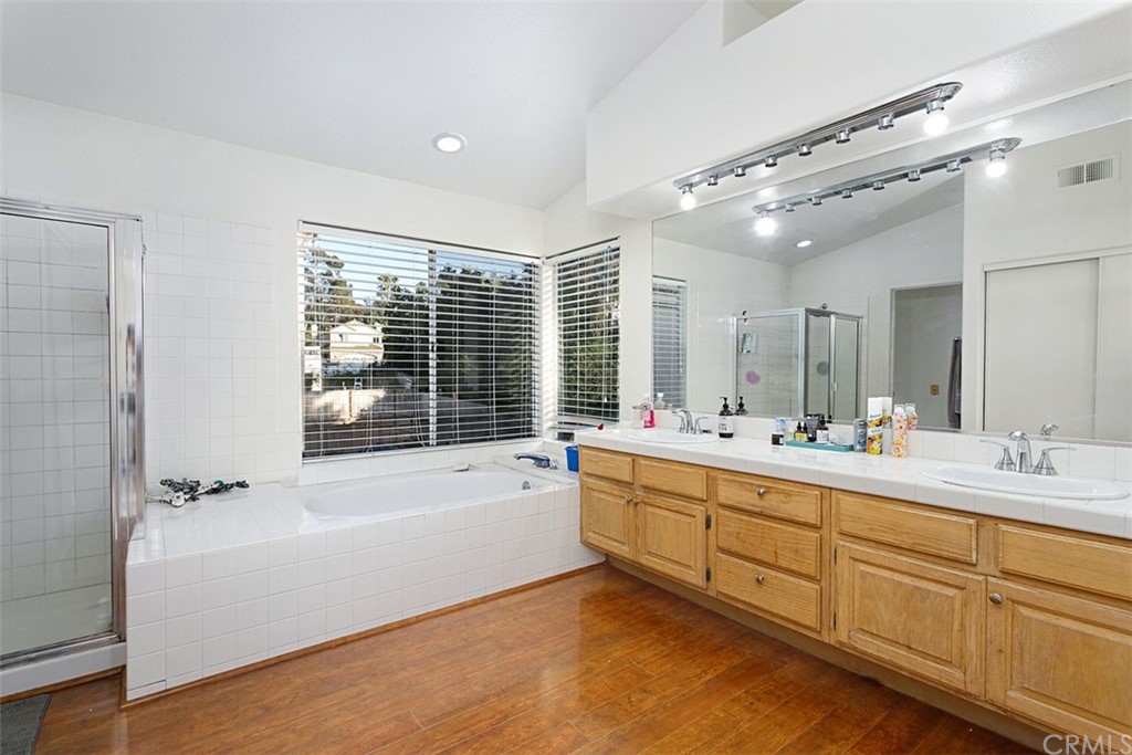 3660 Via Bernardo Oceanside, CA 92056 - Photo 18 of 34 a bathroom with a tub sink shower and mirror