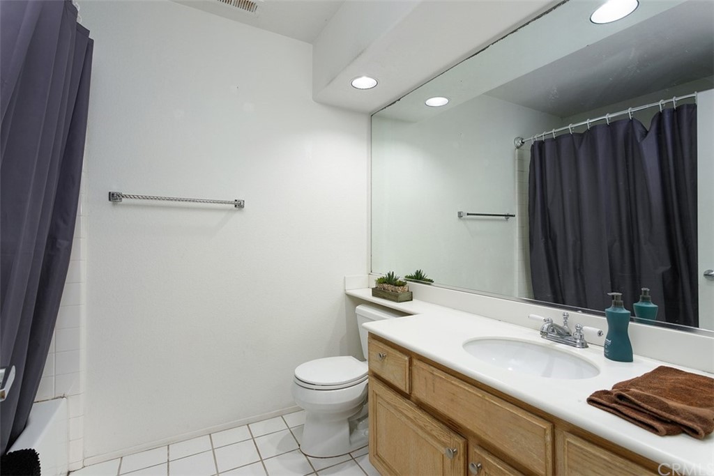 3660 Via Bernardo Oceanside, CA 92056 - Photo 26 of 34 a bathroom with a granite countertop sink a toilet and a mirror