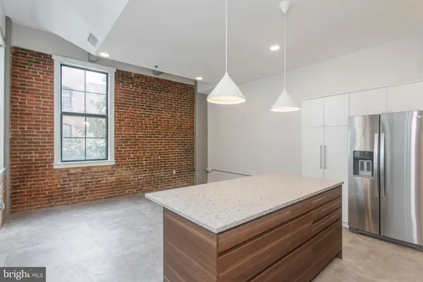a kitchen with a stove and a refrigerator