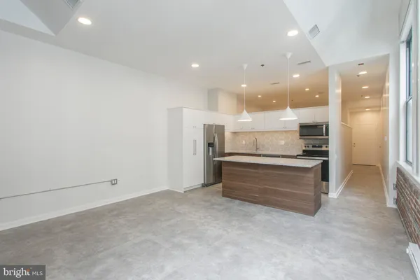 a view of kitchen with center island and stainless steel appliances