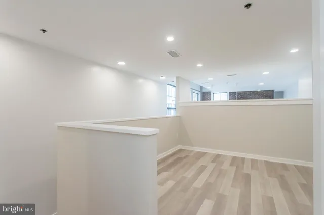 a view of a room with wooden floor and window