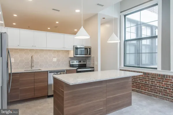 a kitchen with a sink cabinets and window