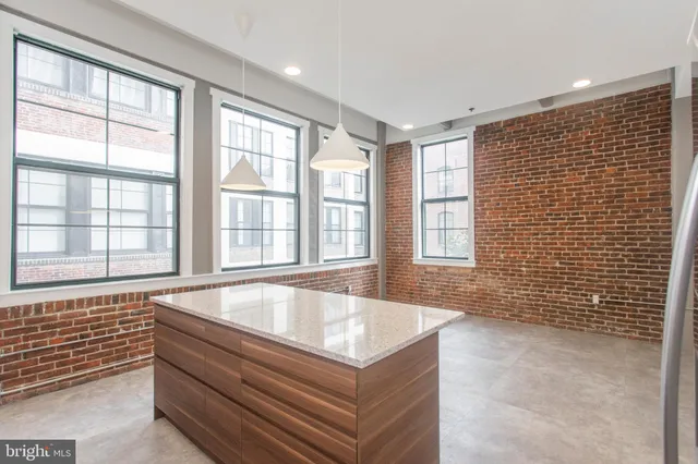 a spacious bathroom with a tub and large windows