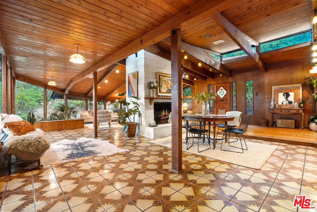 20881 Waveview Drive Topanga, CA 90290 - Photo 16 of 54 a view of a patio with a table and chairs under an umbrella with a patio