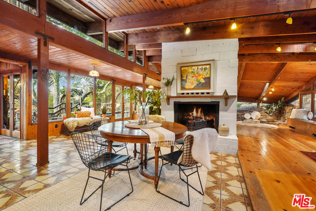 20881 Waveview Drive Topanga, CA 90290 - Photo 3 of 54 a dining room with furniture and a fireplace
