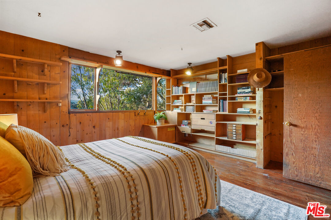 20881 Waveview Drive Topanga, CA 90290 - Photo 26 of 54 a bedroom with a bed and a large window