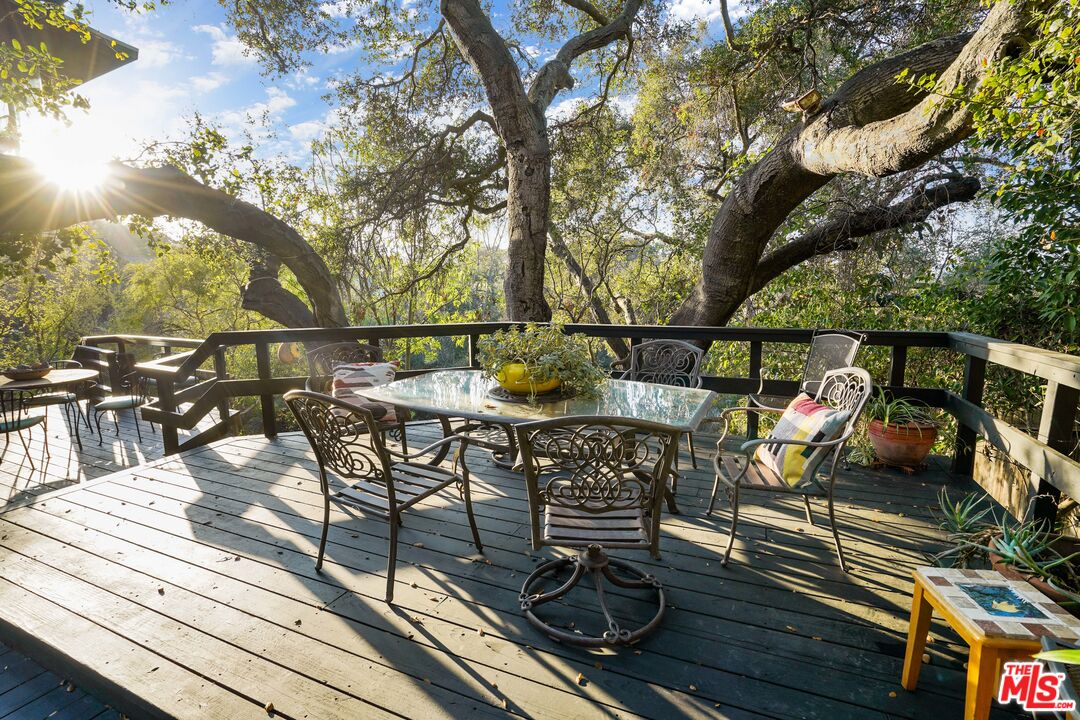 20881 Waveview Drive Topanga, CA 90290 - Photo 36 of 54 a view of a chairs and table on the wooden floor