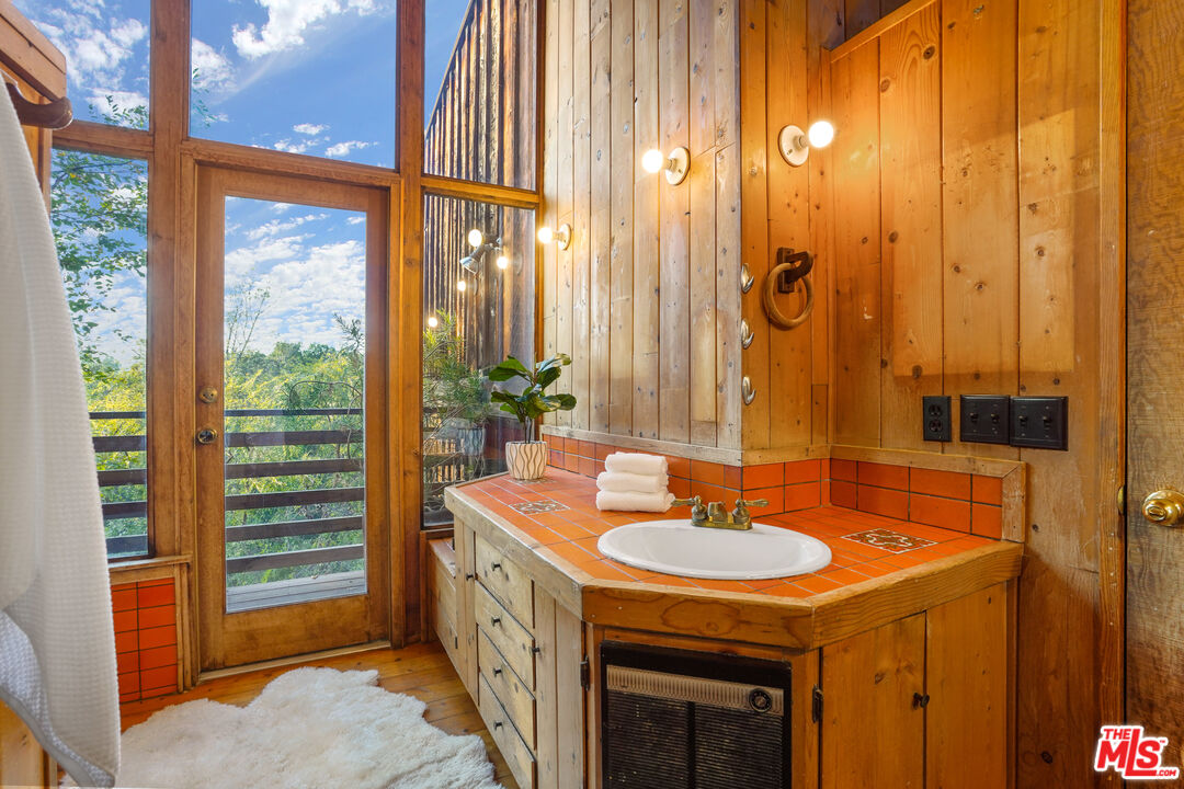 20881 Waveview Drive Topanga, CA 90290 - Photo 37 of 54 a bathroom with a sink a mirror and a shower