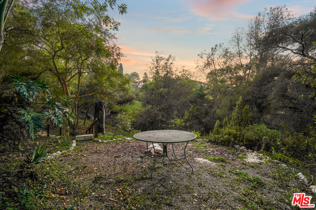 20881 Waveview Drive Topanga, CA 90290 - Photo 49 of 54 a view of a backyard with a fountain plants and large tree