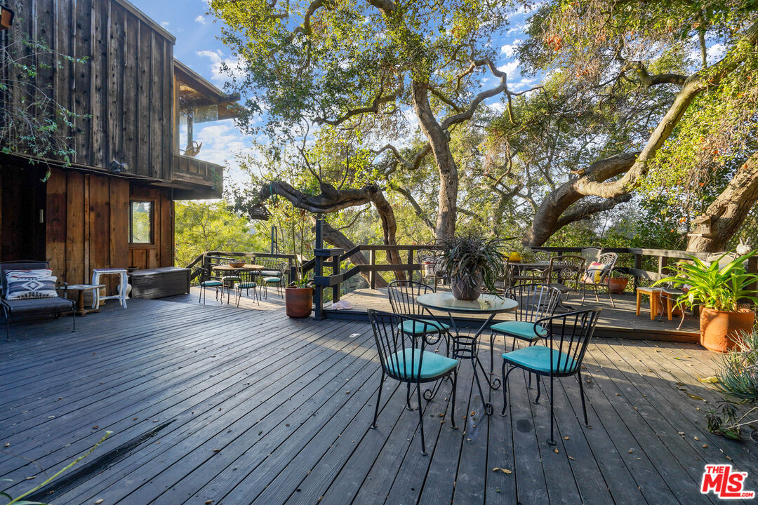 20881 Waveview Drive Topanga, CA 90290 - Photo 51 of 54 a view of a patio with table and chairs and wooden floor