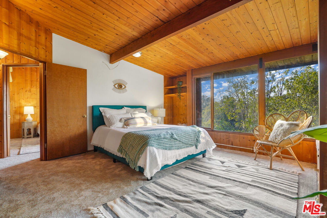 20881 Waveview Drive Topanga, CA 90290 - Photo 9 of 54 a spacious bedroom with a bed and large windows