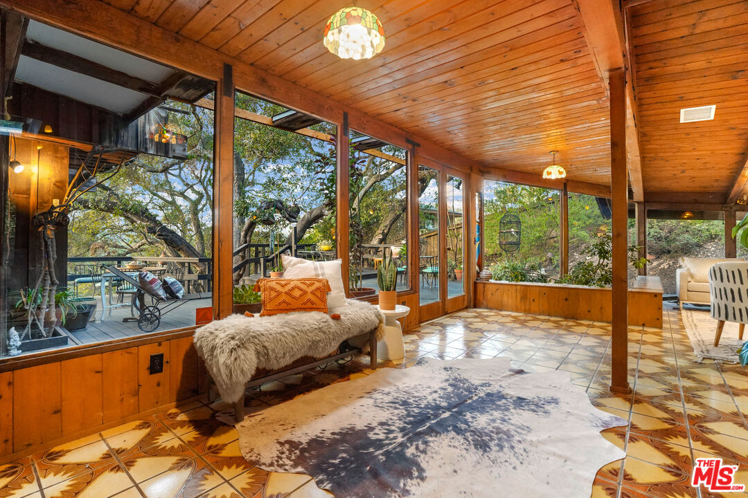 20881 Waveview Drive Topanga, CA 90290 - Photo 10 of 54 a bedroom with furniture and large windows