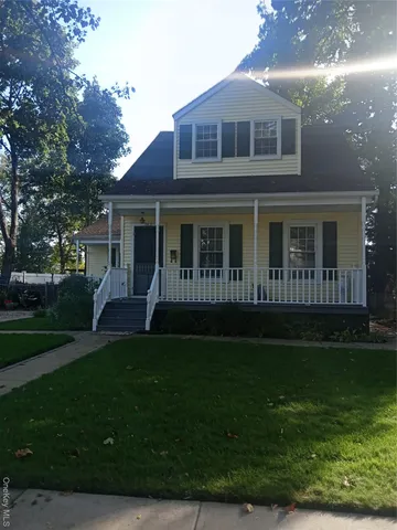 a view of house with yard and green space