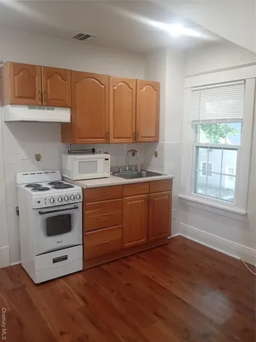 a kitchen with a white cabinets and white appliances