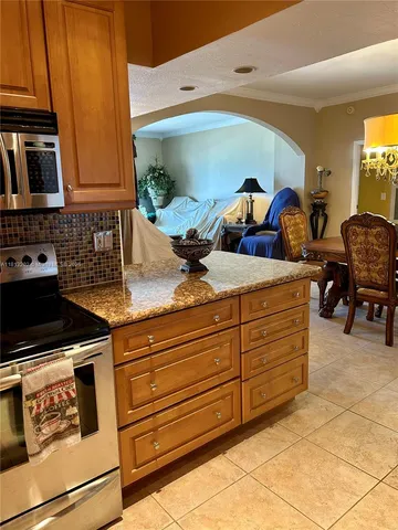 a kitchen with stainless steel appliances granite countertop a sink and cabinets