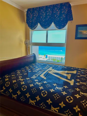 a view of a room with wooden floor and windows