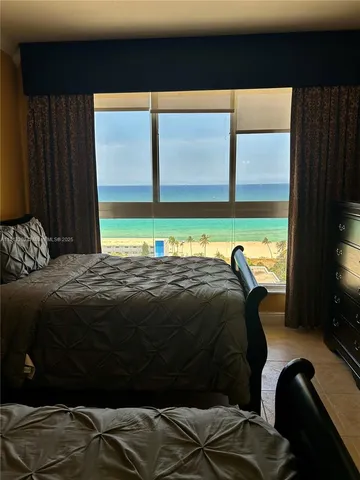 a bedroom with a bed next to a window