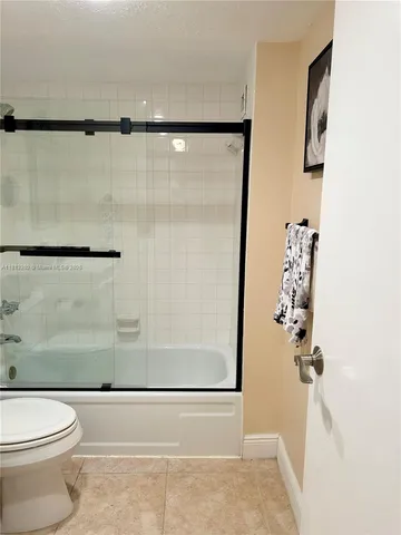 a bathroom with a shower a toilet and a shower