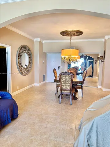 a view of a dining room with furniture and chandelier
