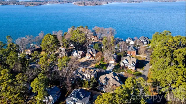 a view of a house with a yard balcony and tree s