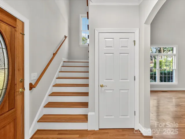 a view of a entryway with wooden floor and staircase